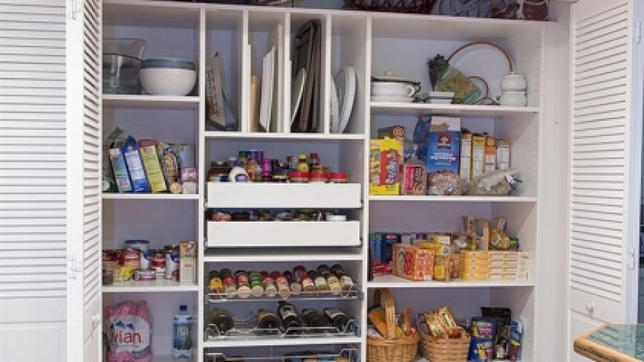 Kitchen pantry with food and other items neatly organized.